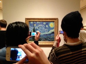 Museumgoers snapping photos of Vincent van Gogh’s Starry Night, 1889, at MoMA. ©2013 REBECCA ROBERTSON